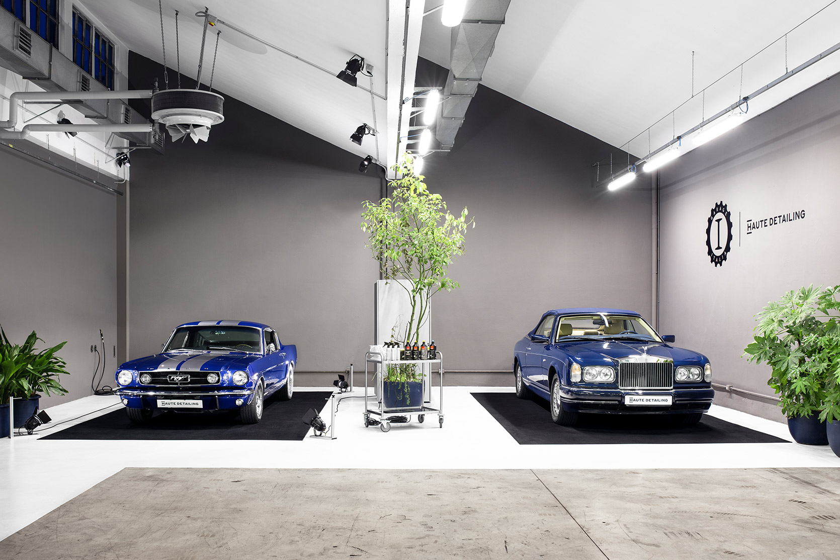 A Ford Mustang And A Rolls Royce Corniche In The Haute Detailing Space At Garage Italia