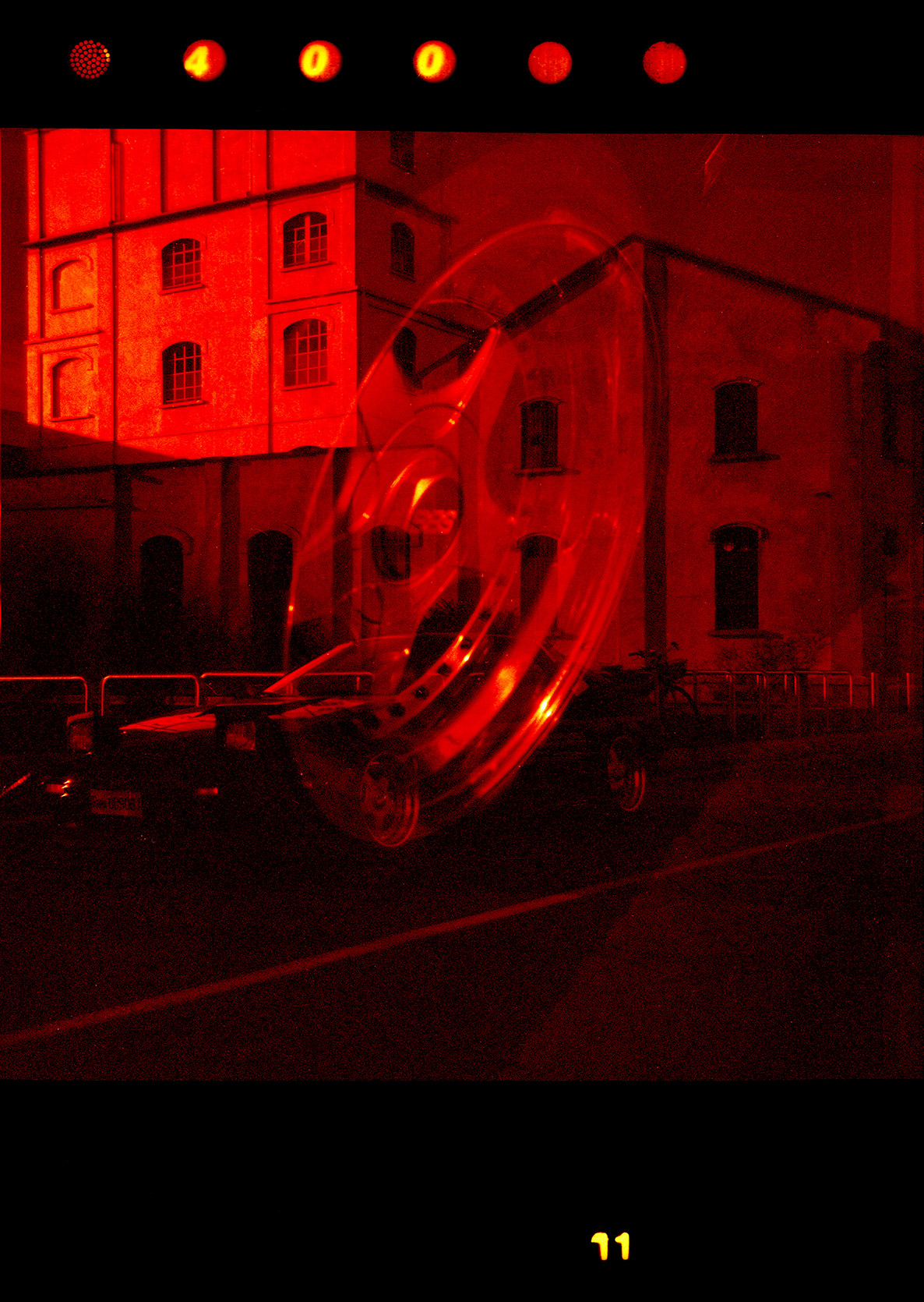 Double exposure of a Mazda Rx-7 FC and its wheels at Fondazione Prada in Milano