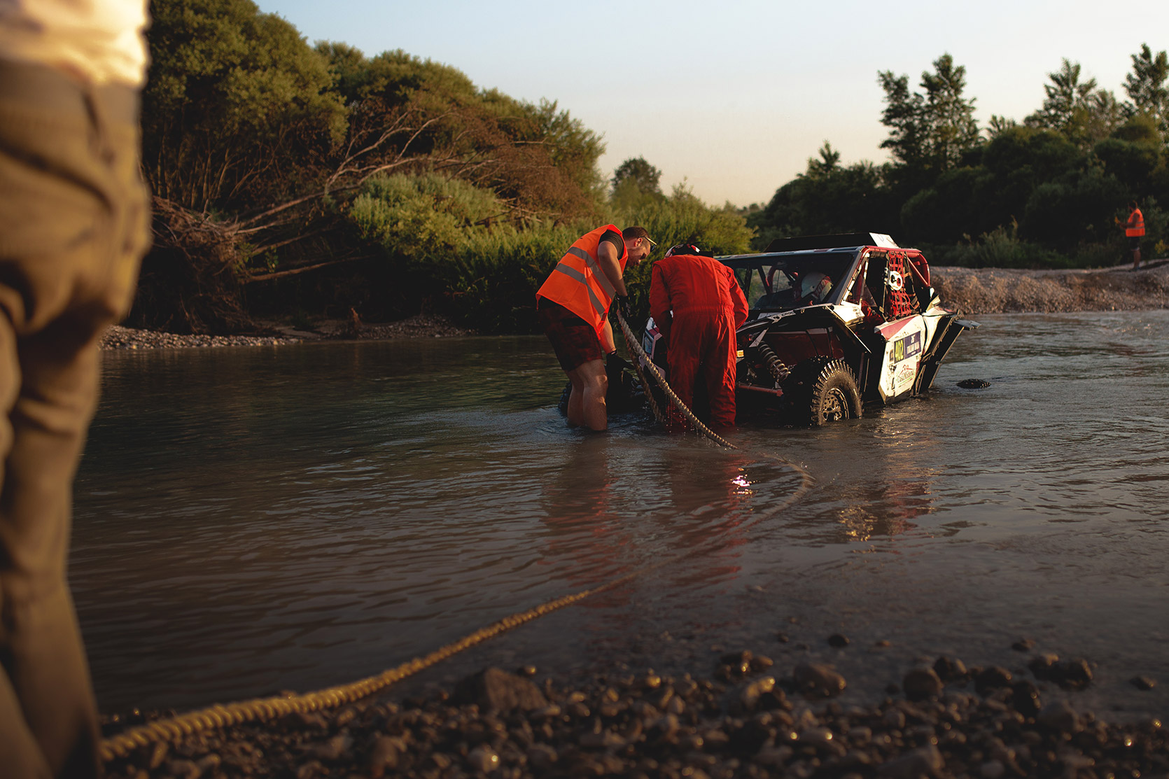 A Marshal is towing a stuck ATV in the water at Italian Baja