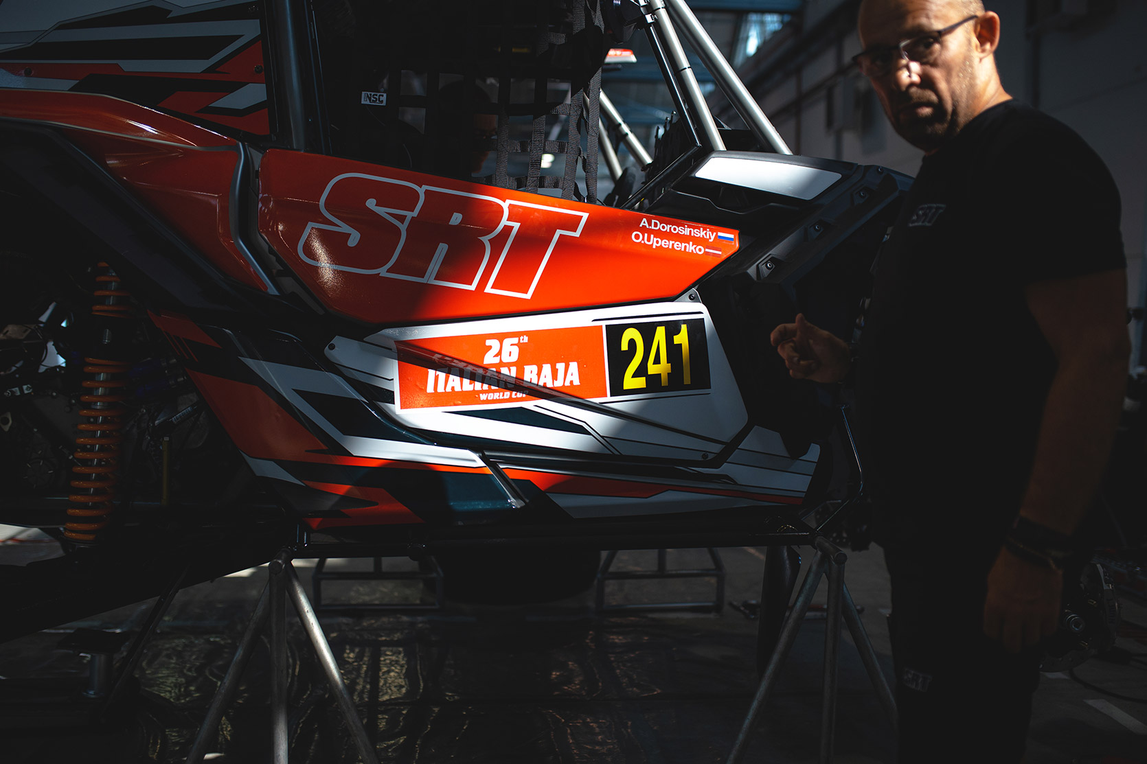 Mechanic working on an ATV at Italian Baja