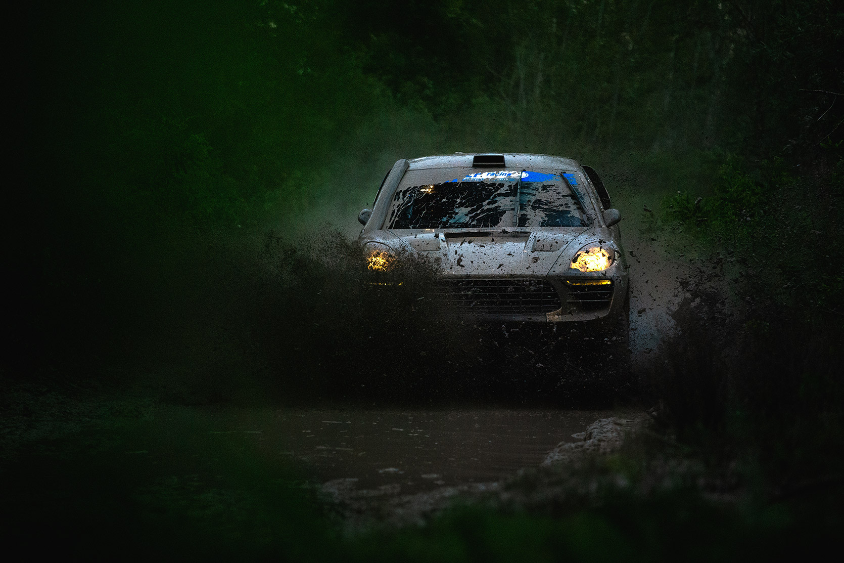 LP Racing on their Porsche Macan passing throught mud at Italian Baja