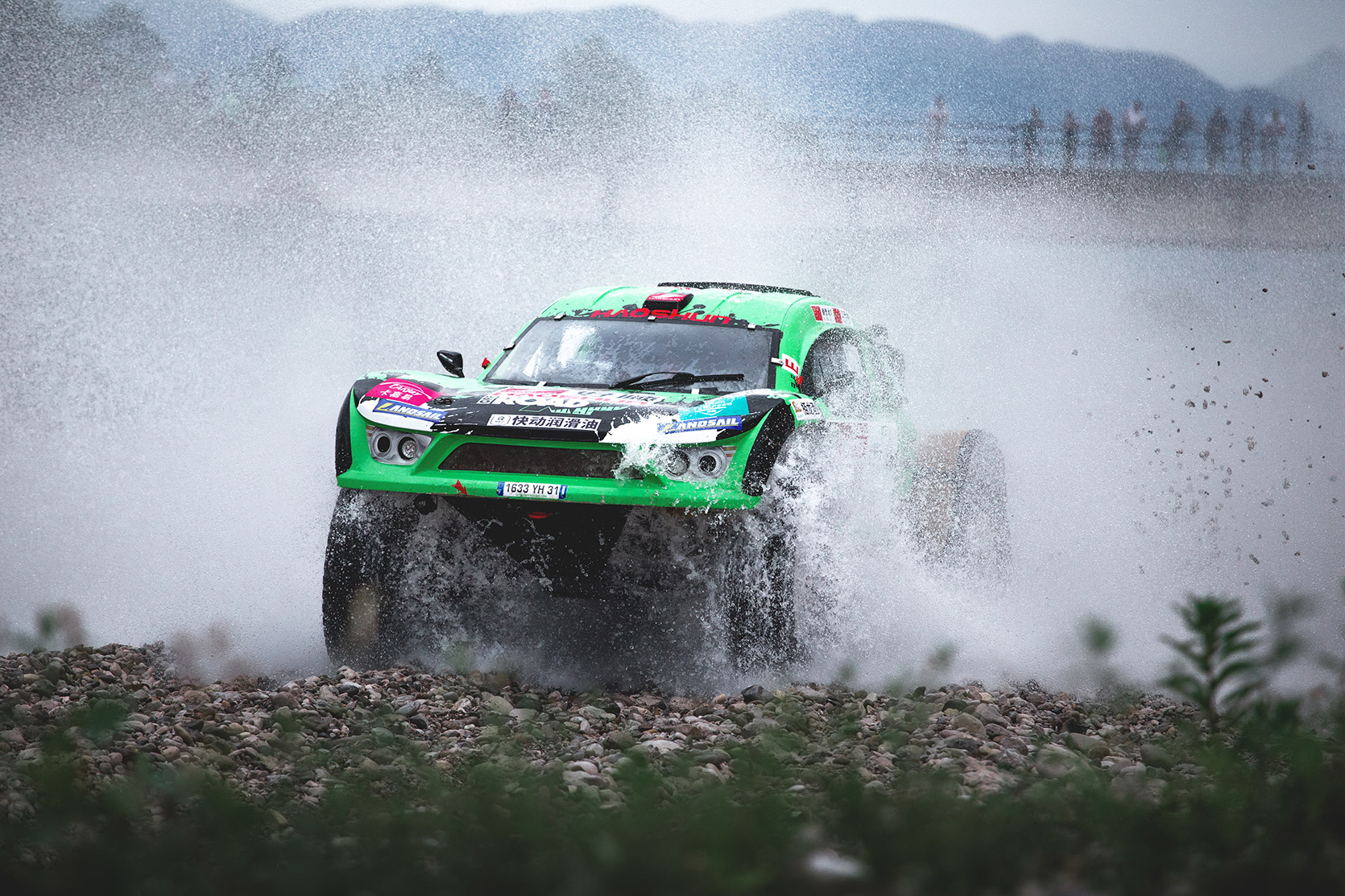 A Volkswagen Off-Road Car passing throught the river at Italian Baja