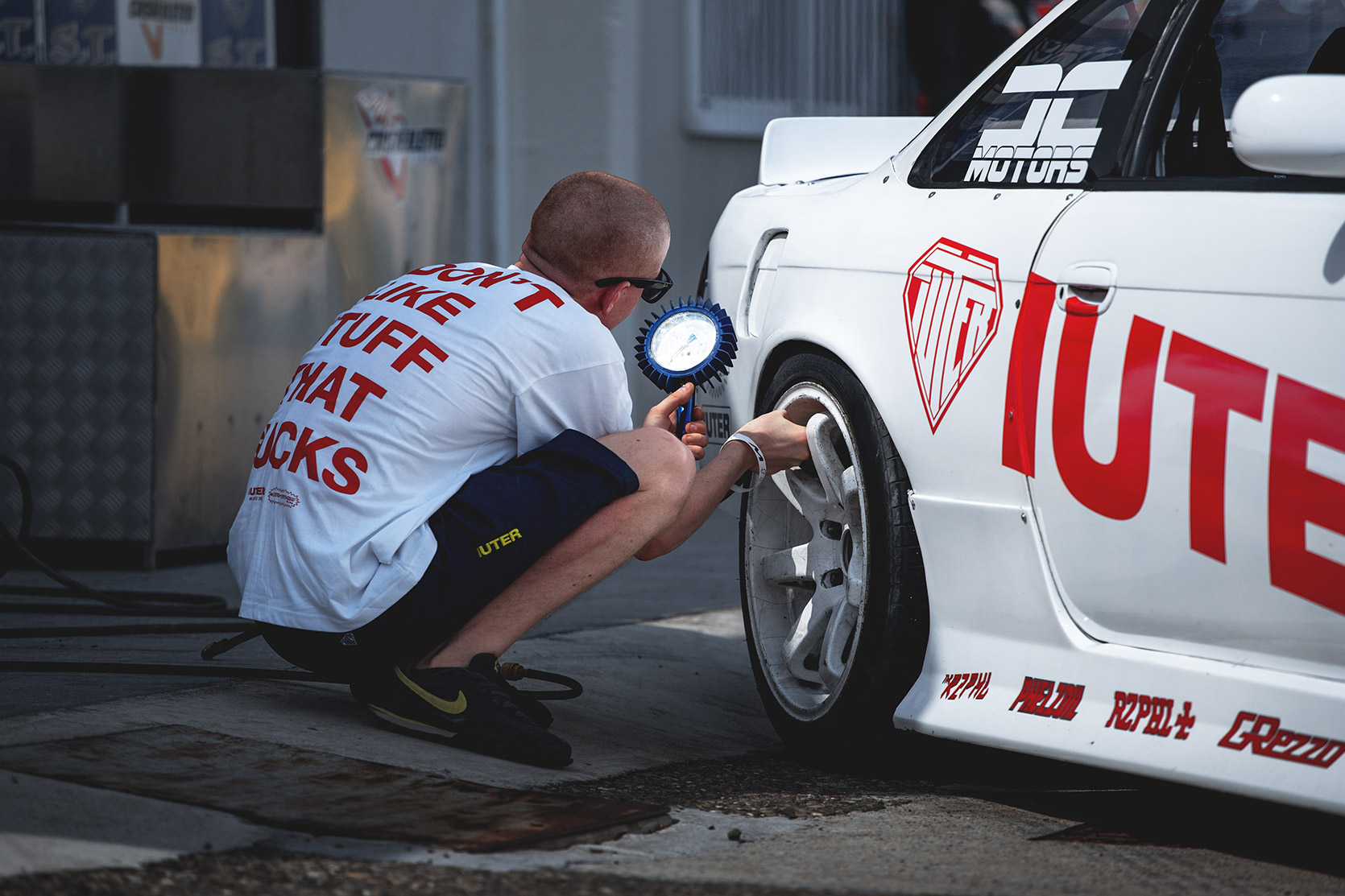 Rizphel checking tyre pressure on his Nissan Silvia S14