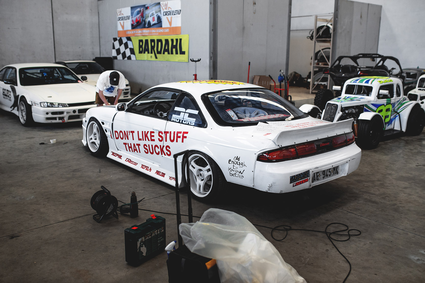 MH working on Rizphel's Nissan Silvia S14 hood in Castelletto Circuit di Branduzzo garage