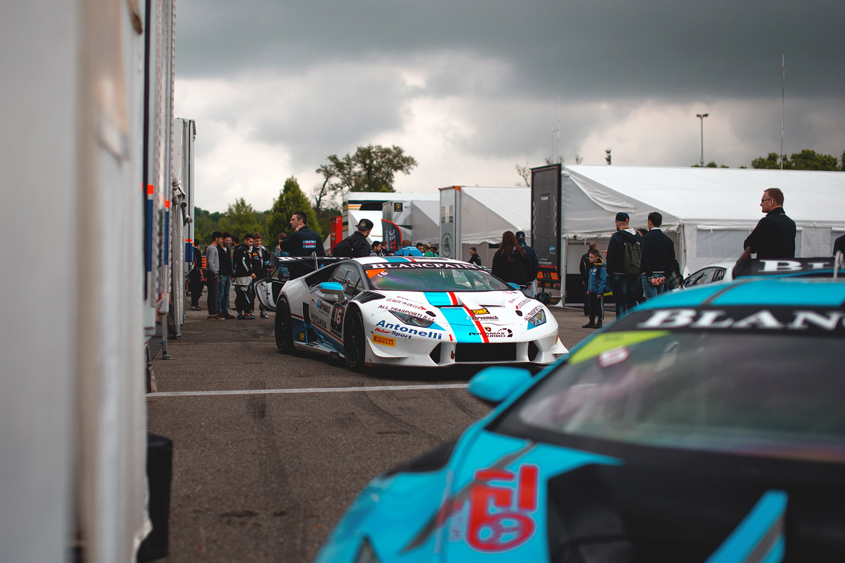 Crowd in the paddock near two Lamborghini Huracan Evo Super Trofeo at Autodromo Nazionale Monza