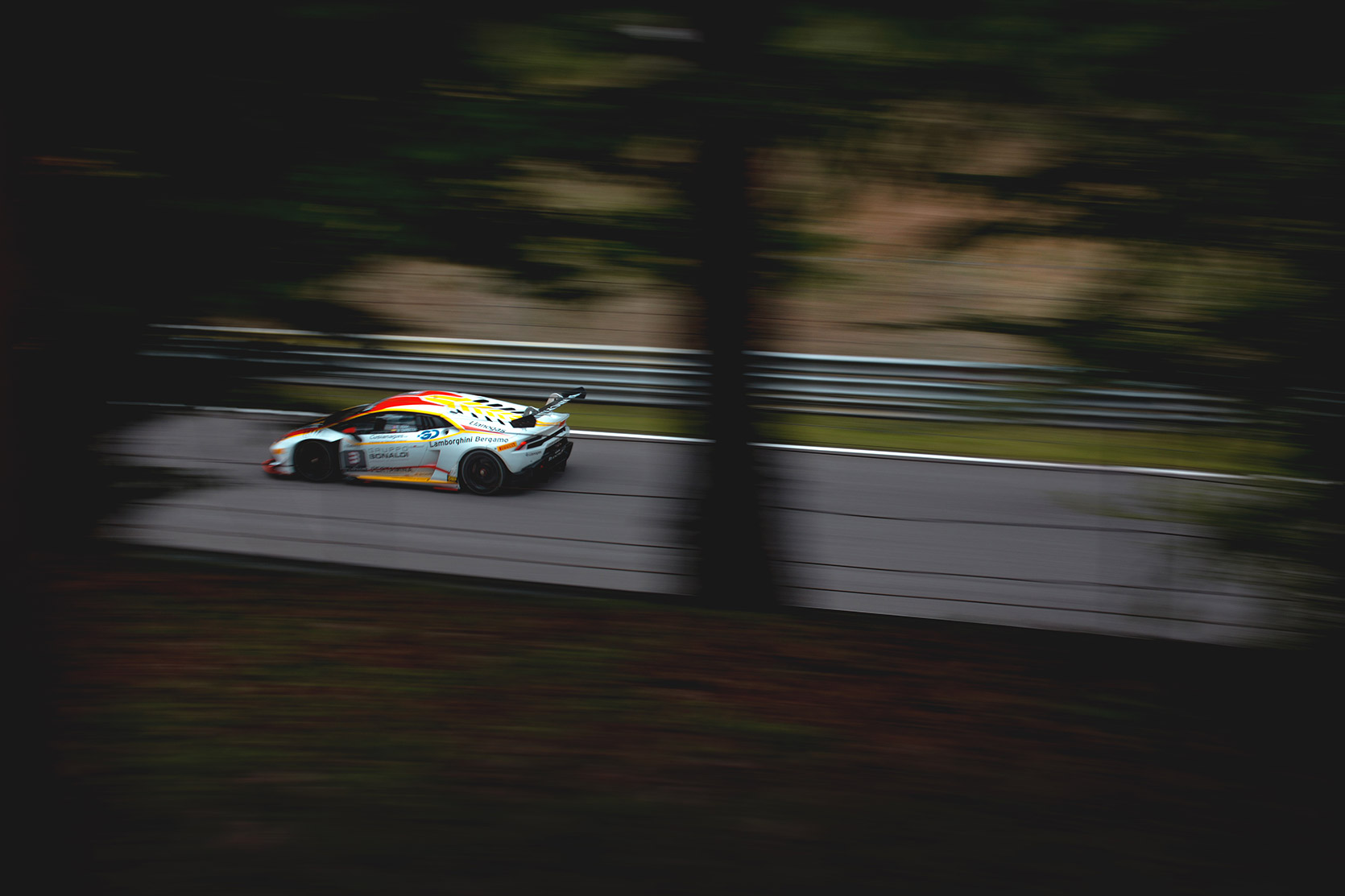 A Lamborghini Huracan Evo Super Trofeo panning throught trees at Autodromo Nazionale Monza