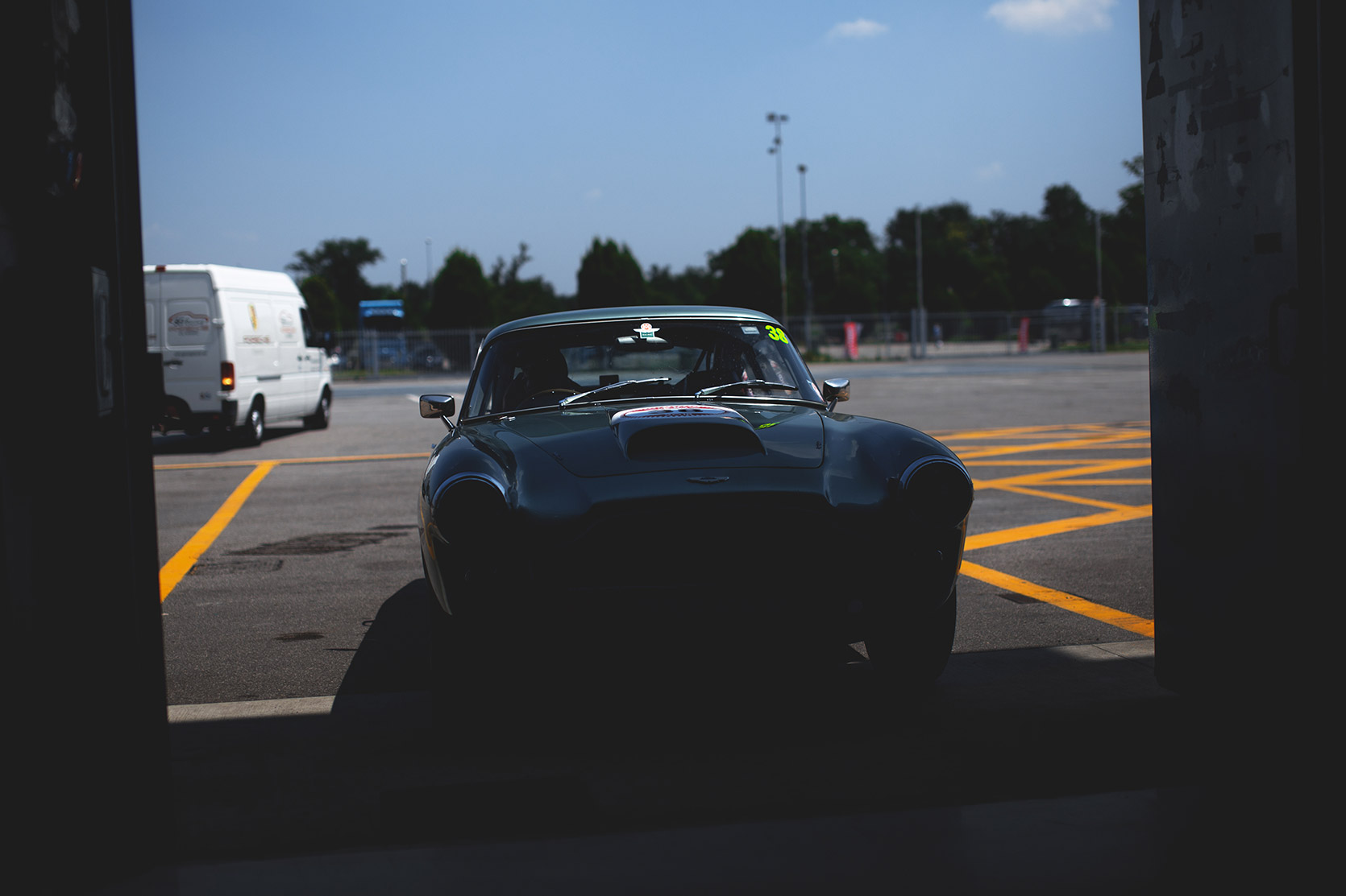 An Aston Martin DB4 entering in a box of Autodromo Nazionale Monza at Modena 100 Ore