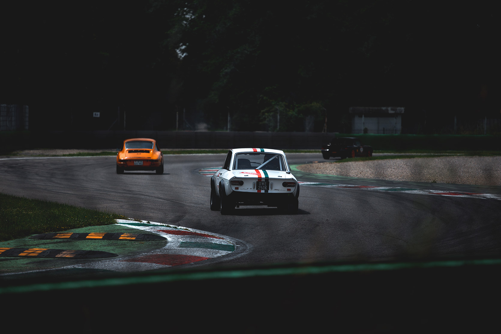 A Lancia Fulvia HF approching the Ascari curve of Autodromo Nazionale Monza at Modena 100 Ore