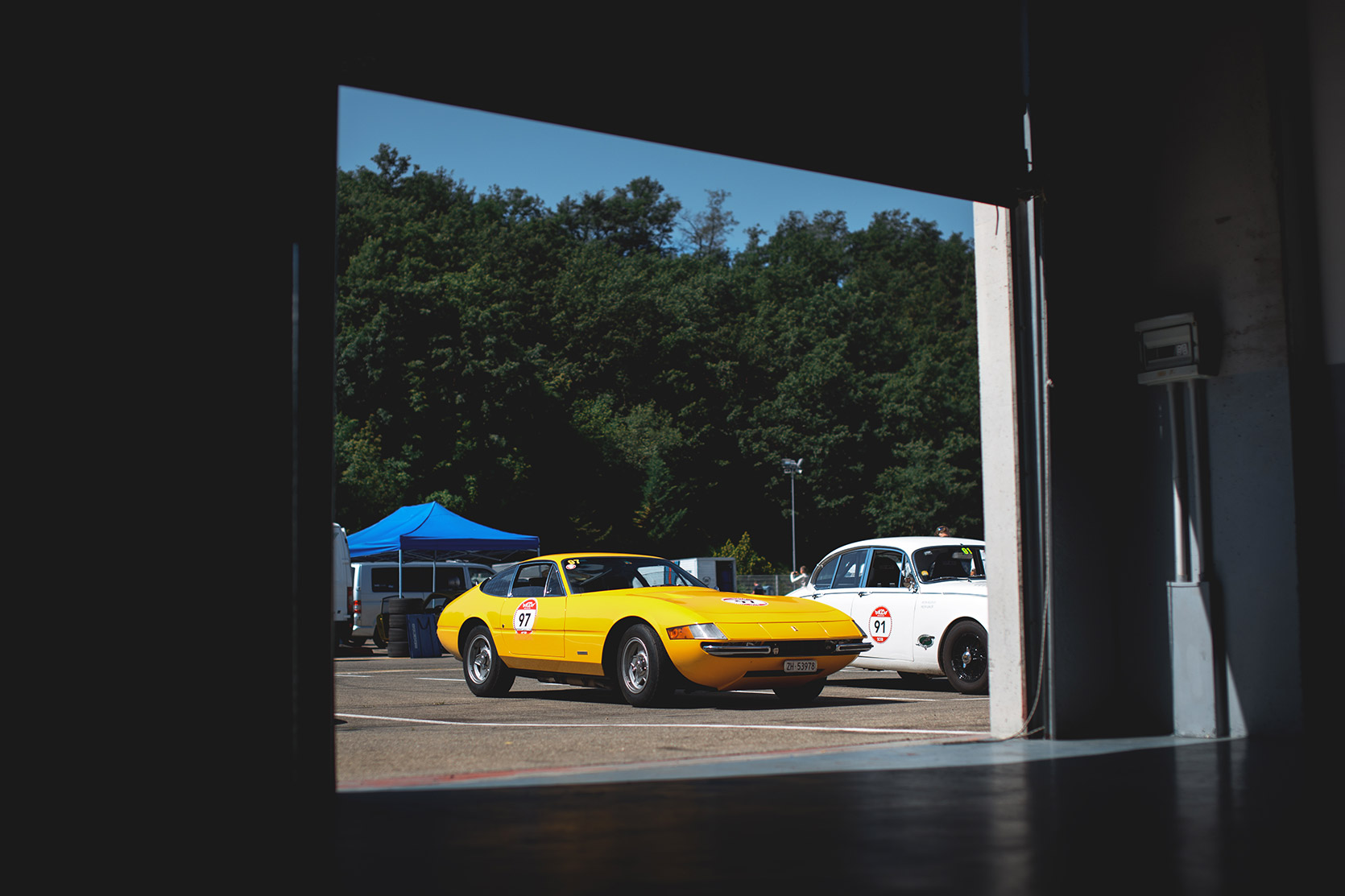 A Ferrari Daytona 365 GTB4 Stradale in the paddock of Autodromo Varano De Melegari at Modena 100 Ore