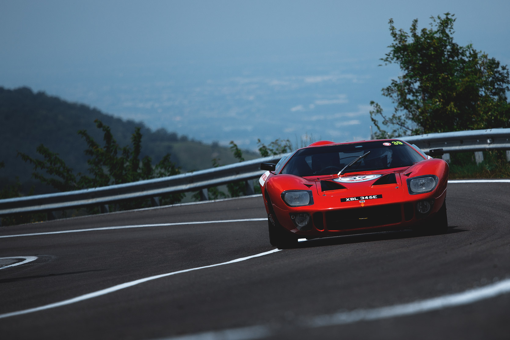 A Ford GT40 approching a curve in the street at Modena 100 Ore at Modena 100 Ore