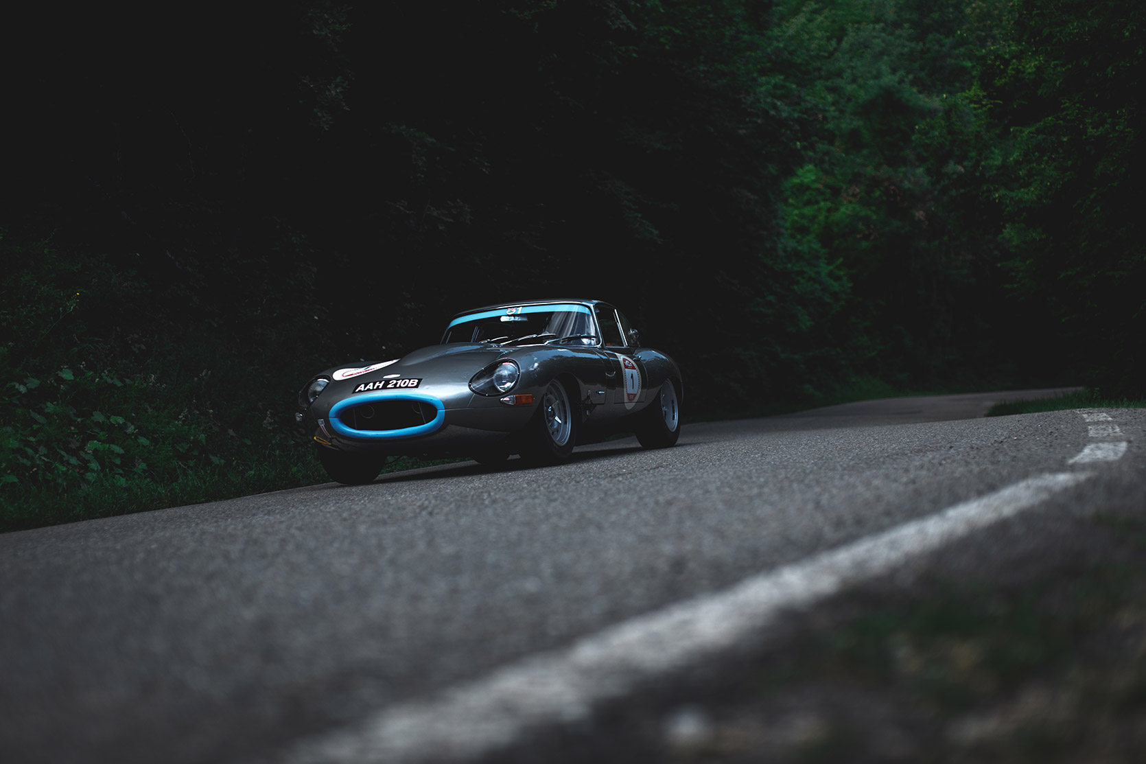 A Jaguar E-Type passing down the street at Modena 100 Ore