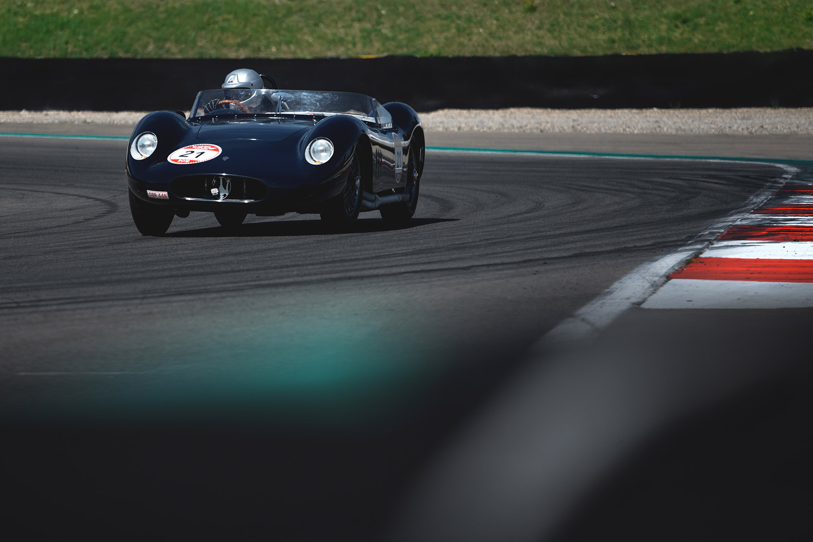 A Maserati 250S approching a curve in Autodromo Varano De Melegari at Modena 100 Ore