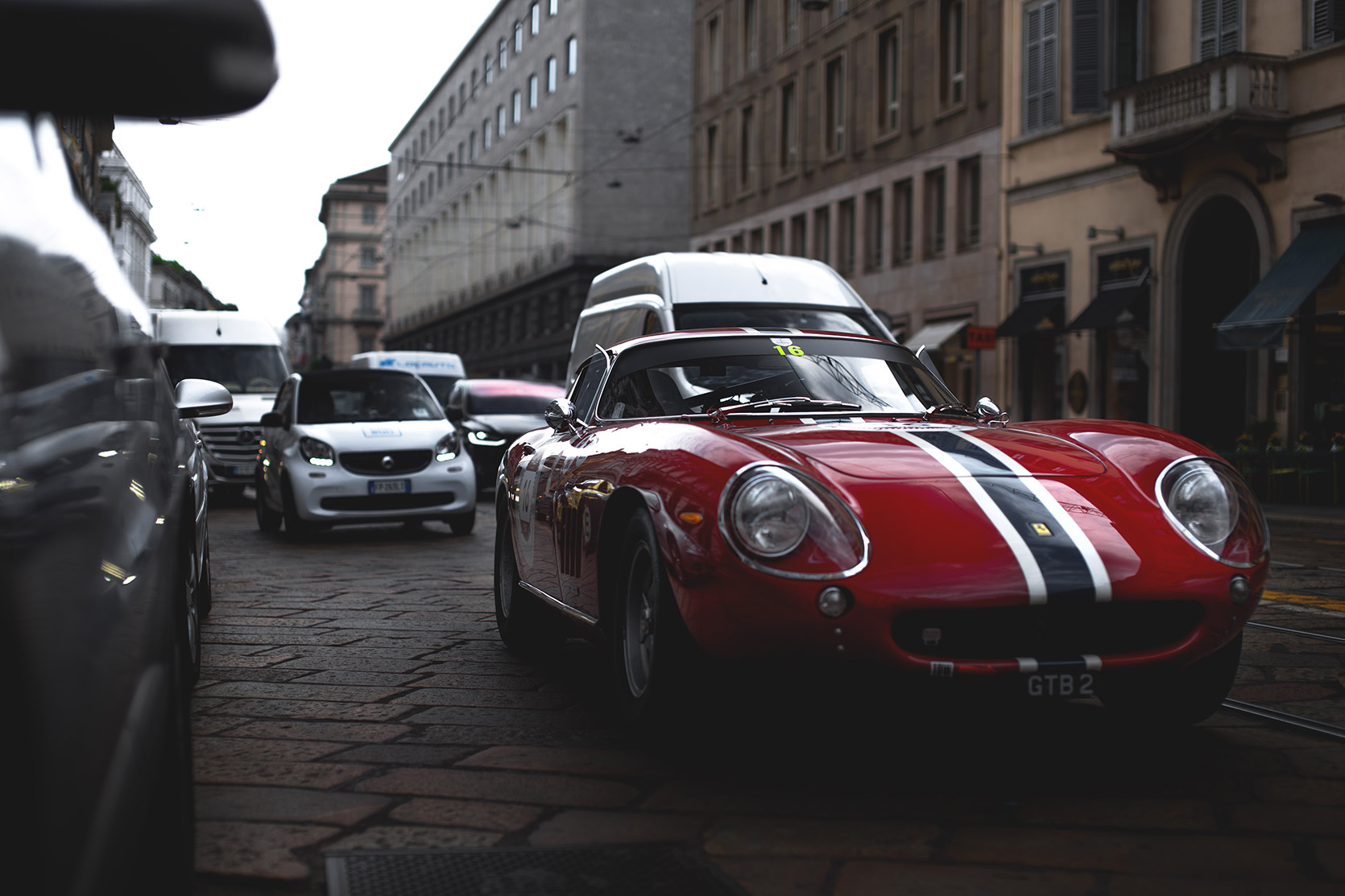 A Ferrari 275 GTB in the traffic of Milano at Modena 100 Ore