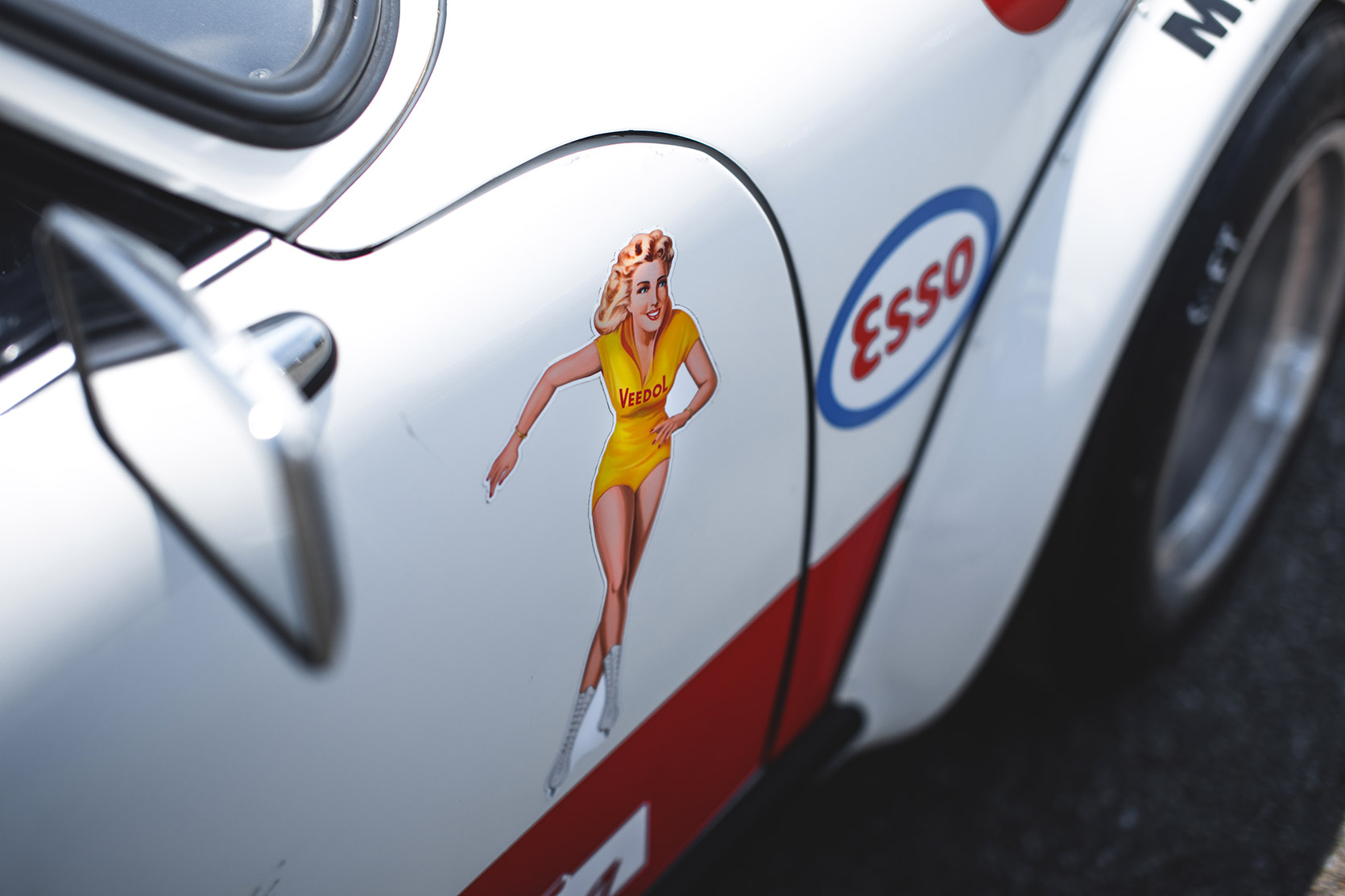 A Pin Up Sticker on a Porsche's fender in the paddock of Autodromo Nazionale Monza at Modena 100 Ore