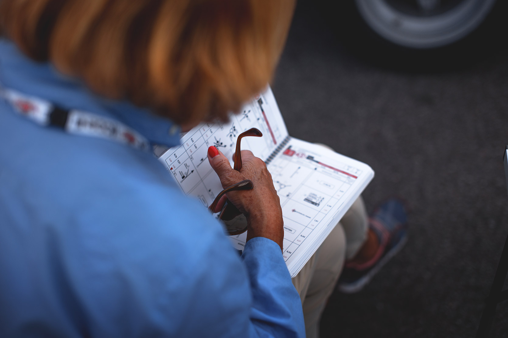 A Lady reading the Modena 100 Ore Road-book in the paddock of Autodromo Nazionale Monza at Modena 100 Ore