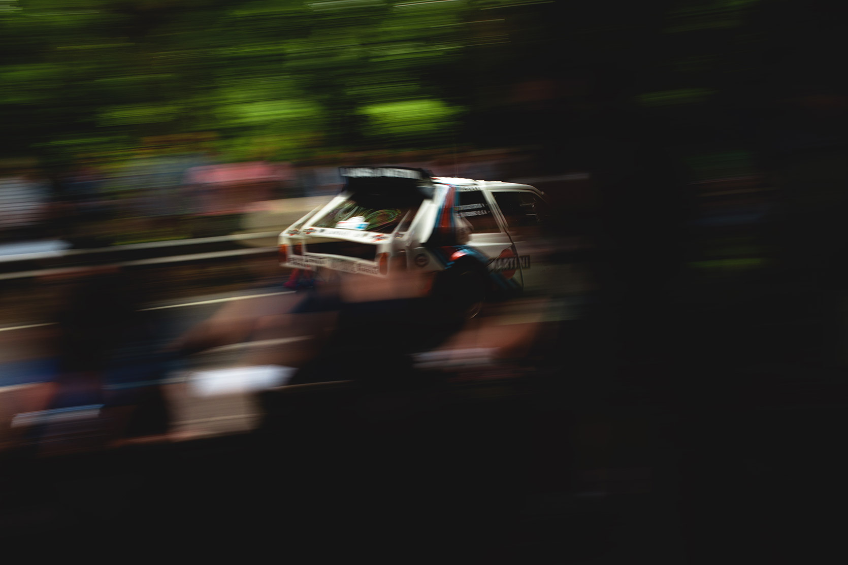A Lancia Delta S4 panning throught trees and crowd at Vernasca Silveer Flag